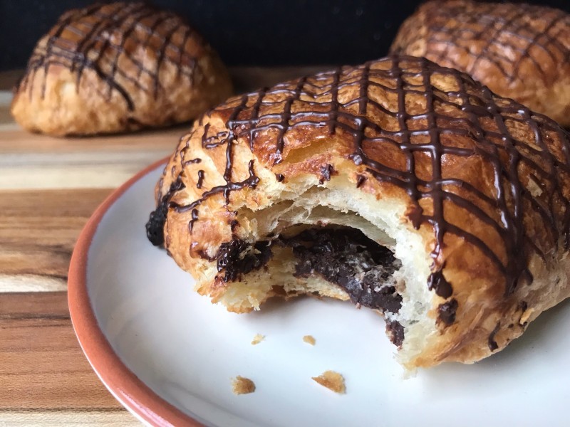 chocolate croissant with a bite out of it