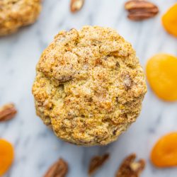 Toasted Oat, Pecan & Flaxseed Scone with apricots and pecans scattered around