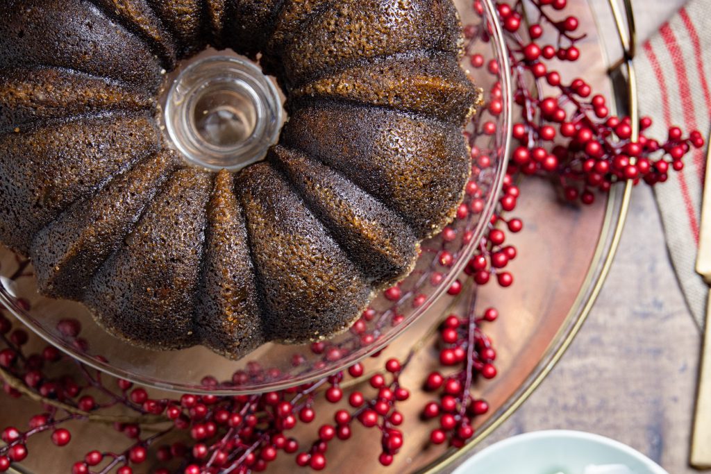 overhead view of a gingerbread coffee cake with red berries
