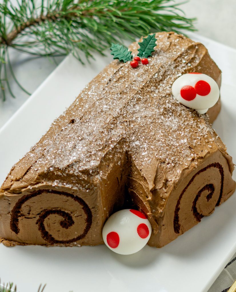 whole Buche de Noel cake decorated with edible mushrooms