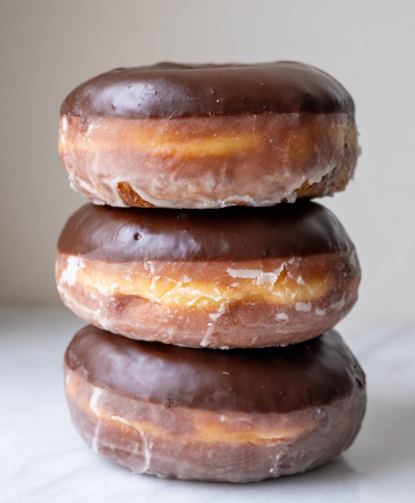 a stack of three chocolate doughnuts