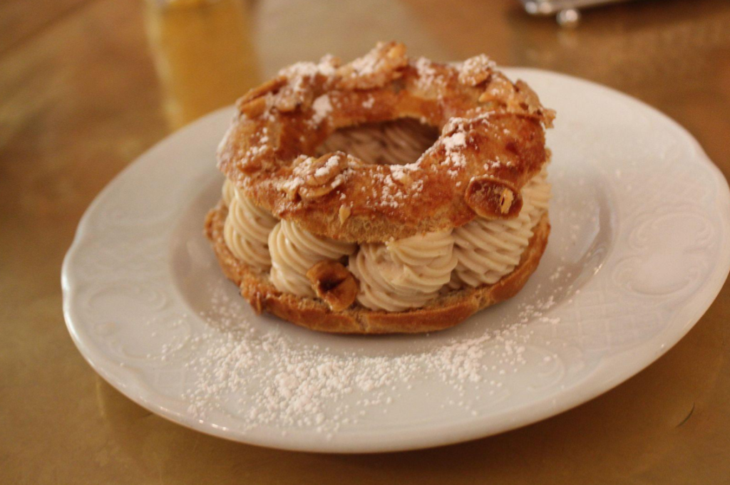 A variation of Louis Durand’s original Paris Brest, featuring an almond-studded ring of pâte à choux split in half horizontally and filled liberally with praline crème mousseline. [Photo source: Wikipedia]