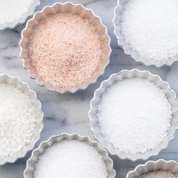 various types of salt in small metal dishes