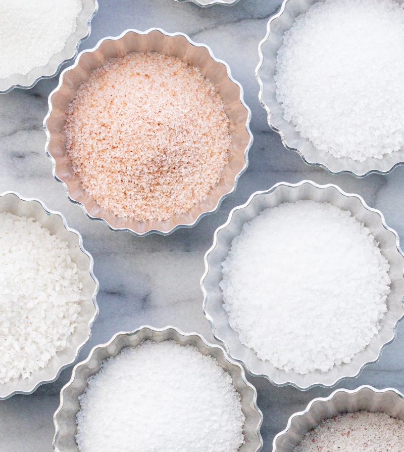 various types of salt in small metal dishes