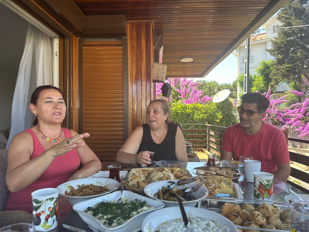 people on a balcony eating a meal