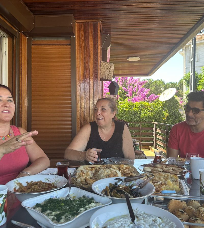 people on a balcony eating a meal