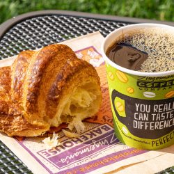 Ari's Pick: Cultured Butter Croissants from the Bakehouse croissant and coffee on a patio table