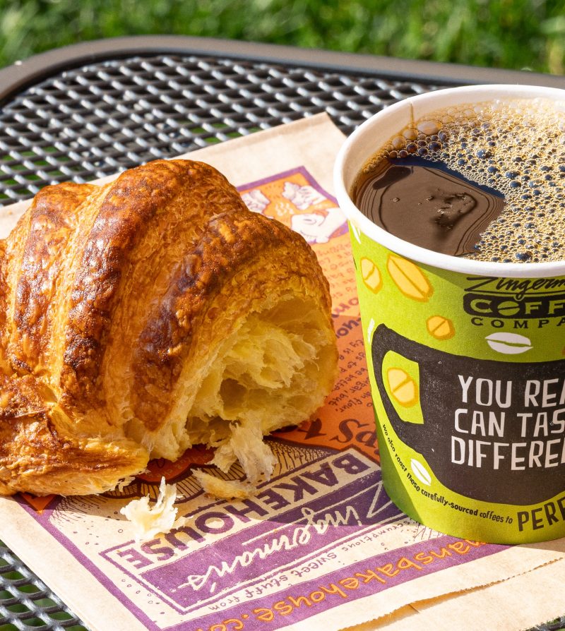 croissant and coffee on a patio table