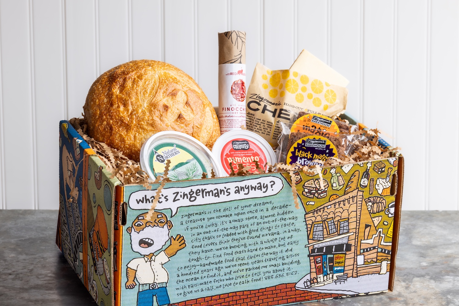 a cartoon gift box filled with bread, spreads, cheese, and brownies
